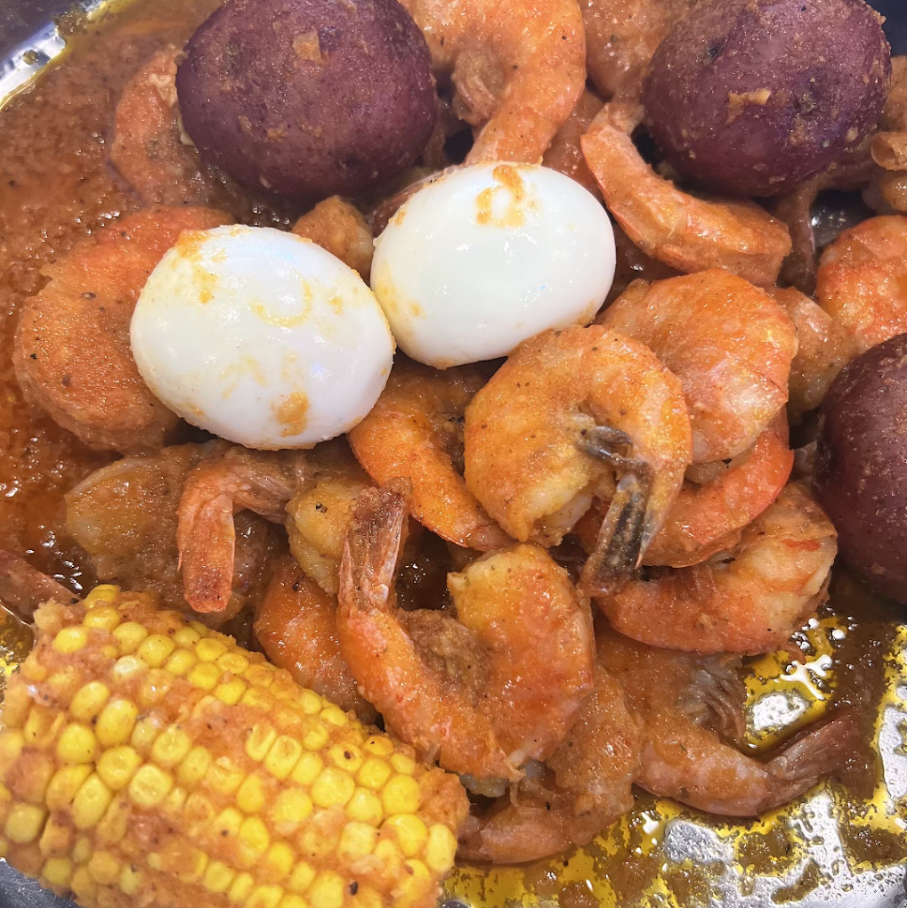 Authentic Cajun seafood boil and garlic noodles prepared fresh at Captain Crawfish Coffee Road